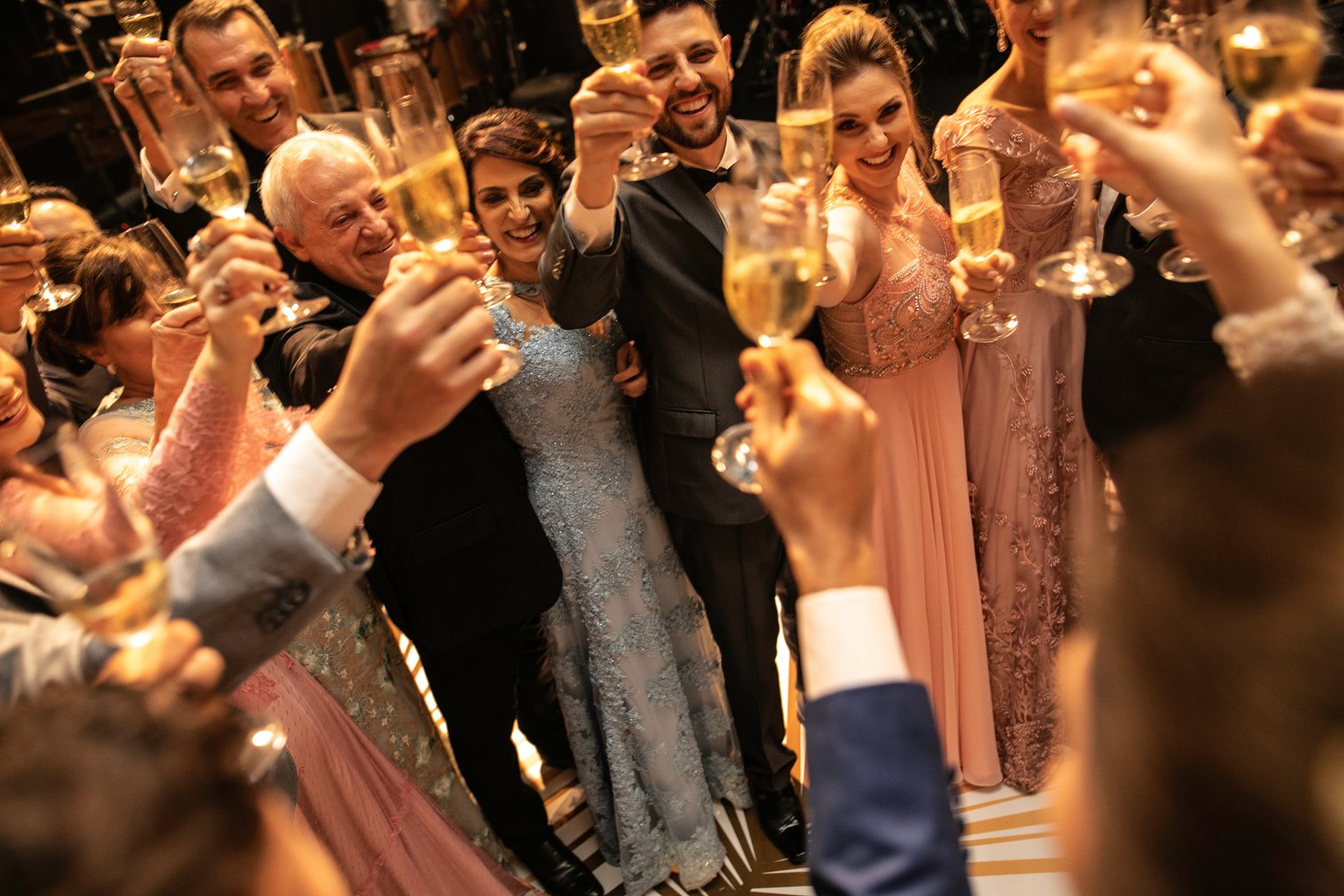 Bride, groom and wedding guests making a toast